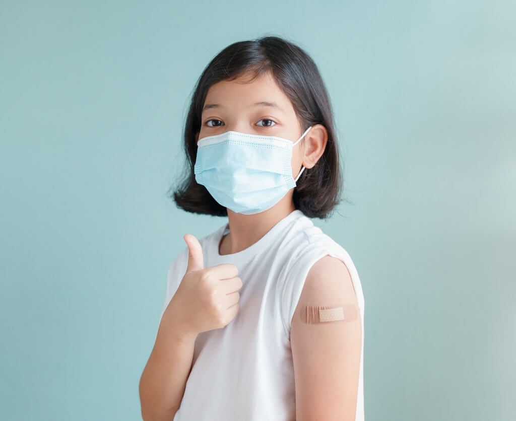 Little girl thumbs up after getting COVID-19 vaccine